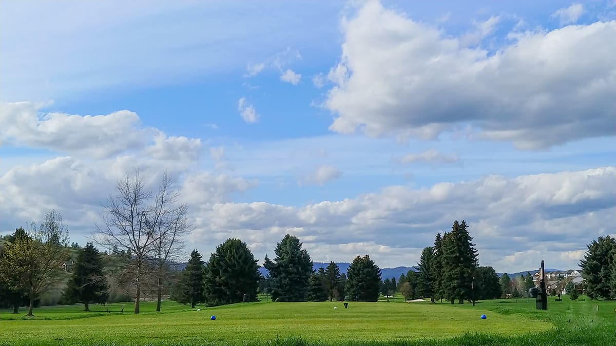 A fairway at Trailhead Golf Course under spring clouds